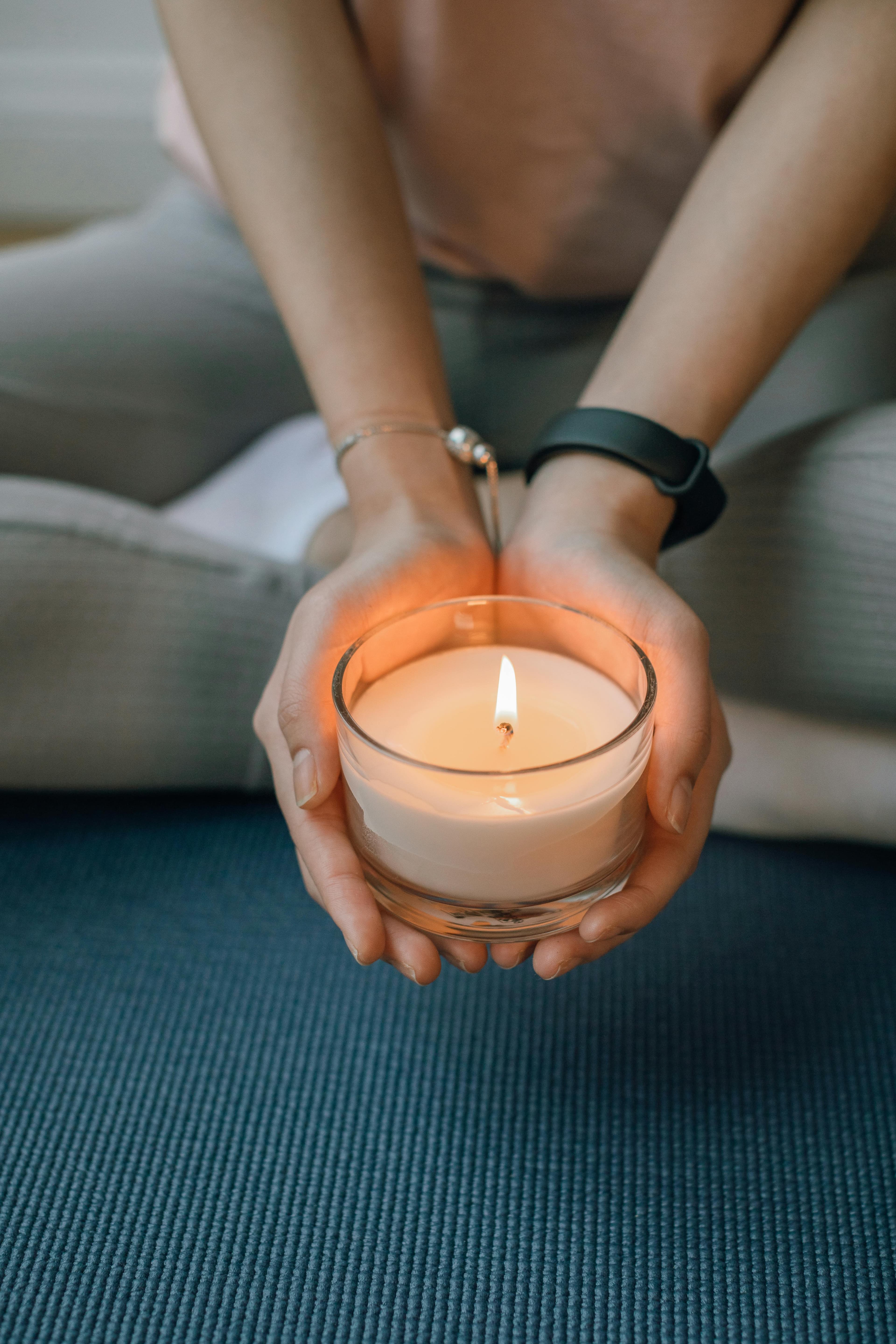 Peaceful meditation with hands in mudra position, warm golden lighting